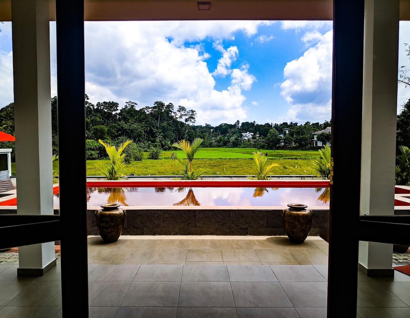 Interior doorway framing the red pool and countryside